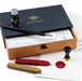 Calligraphy set with ink bottle, pen, and wax seals in a Manuscript box.